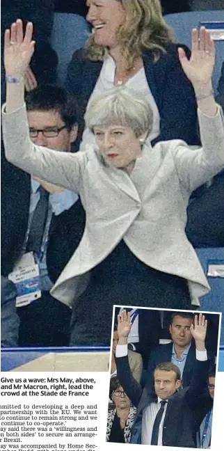  ??  ?? Give us a wave: Mrs May, above, and Mr Macron, right, lead the crowd at the Stade de France