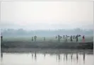  ??  ?? HANNAH MCKAY/REUTERS Rohingya refugees continue their way after crossing from Myanmar into Palong Khali, near Cox’s Bazar, Bangladesh, on November 2, 2017.