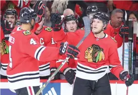  ?? GETTY IMAGES ?? McCabe (right) celebrates after scoring against the Coyotes on Friday.