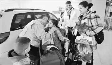  ??  ?? Iraqi refugee Amira Al-Qassab (right) and three of her children are greeted by a relative picking them up from at Detroit Metro Airport in Romulus, Michigan, US. — Reuters photo