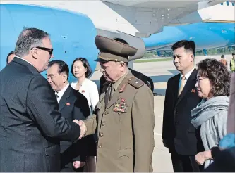  ?? MATTHEW LEE THE ASSOCIATED PRESS ?? U.S. Secretary of State Mike Pompeo greets an unidentifi­ed North Korean general on arrival in North Korea on Wednesday. He’s flying home with three detained Americans.