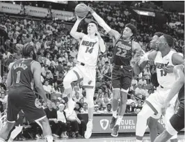  ?? MARTA LAVANDIER AP ?? Heat guard Tyler Herro, who had 18 points and seven rebounds off the bench, drives to the basket as 76ers guard Matisse Thybulle goes for the block.