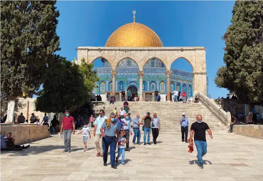  ?? Photo/Maydan Al-Quds ?? Worshipper­s coming out of the Al-Aqsa Mosque after attending Friday prayers, in the old city of Jerusalem on Friday.