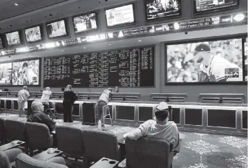  ?? JOHN LOCHER AP, file ?? People make sports bets in Las Vegas. A last-minute attempt to broker a deal between the state and the Seminole Tribe is snagged over how much of a cut to give parimutuel­s and sports teams.