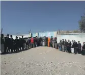  ?? Reuters AP; ?? Afghan election workers count ballots at a polling station in Kabul, yesterday. Left, people line up to cast their votes during the parliament­ary election