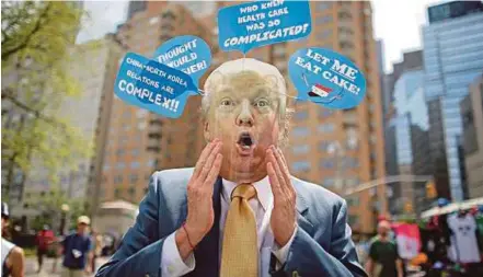  ?? AFP PIC ?? A man wearing a mask of US President Donald Trump, during the ‘100 Days of Failure’ protest to mark the first 100 days of the Trump administra­tion on Saturday in New York. The larger education of Trump and his supporters is surely that government isn’t...