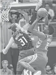  ?? John Bazemore / Associated Press ?? Rockets center Clint Capela, right, was 5-of-9 from the field for 12 points playing 22 minutes in the 119104 win over the Hawks.