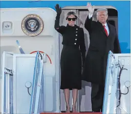  ?? Luis M. Alvarez The Associated Press ?? President Donald Trump and first lady Melania Trump wave goodbye Wednesday morning as they board Air Force One at Joint Base Andrews, Md.