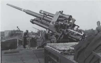  ??  ?? ■ Left and right: Men of the rail Flak, or Eisenbahn Flak. This is the 4. Batterie (Schwere) Flakabteil­ung 535 (Eisenbahn) in Berlin in December 1943. The rail Flak gave the Germans a strategic reserve they could send to defend critical areas as need arose. The Flak built more and more stationary emplacemen­ts to conserve men and materials as the war dragged on, thus rail Flak became one of the few mobile assets Germany possessed after the invasion of Europe and the loss of many units in France. These units were armed with the most capable anti-aircraft gun of the war: the 128mm. These 25-ton monsters could only be mounted on massive Flak towers or railway wagons as seen here. The men of the rail Flak were the elite of anti-aircraft forces, provided the best training and equipment including rail-mounted gun laying radars.