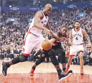  ?? FRANK GUNN/THE CANADIAN PRESS ?? Toronto Raptors forward Serge Ibaka, left, strips the ball from Portland Trail Blazers forward Maurice Harkless in the first half in Toronto on Sunday. The Raptors won 112-106.