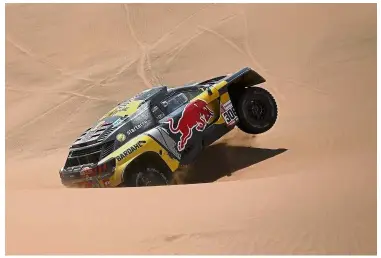  ?? — AFP ?? Battling on: Peugeot’s French driver Sebastien Loeb and co-driver Daniel Elena of Monaco compete in the Dakar Rally Stage Five between Tacna and Arequipa in Peru on Friday.