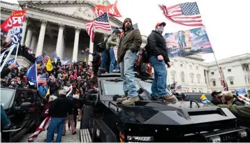  ??  ?? It was a real-life Hollywood action blockbuste­r: Some dexterous rioters — Spiderman-like — scaled towering walls, while others overran security and took over the Capitol building