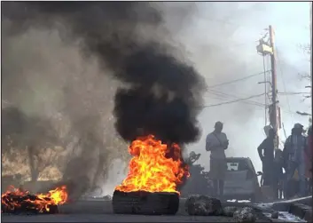  ?? LUCKENSON JEANTV — AFP VIA GETTY IMAGES ?? This screen grab taken from AFPTV shows tires on fire near the main prison of Port-auprince, Haiti, on March 3after a breakout by several thousand inmates.