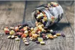  ??  ?? Dehydrated fruit is a great snack to take when backpackin­g. Trail mix is a great snack to bring along on a day hike.