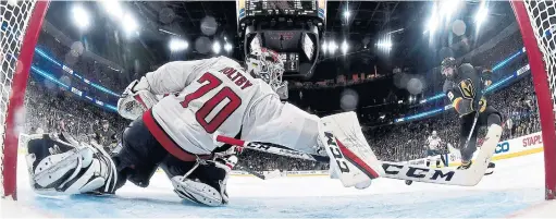  ?? JEFF BOTTARI/GETTY IMAGES ?? Capitals goalie Braden Holtby makes a diving stick save on Golden Knights forward Alex Tuch in Game 2 of the Stanley Cup final on Wednesday night in Las Vegas.