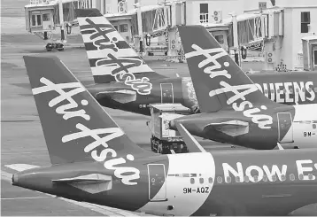  ?? — Reuters photo ?? Higher fuel prices weighed, particular­ly on AirAsia X Bhd where they increased by around 25 per cent from a year earlier.The unit reported a second-quarter loss of RM57.5 million, reversing a profit of RM47.4 million a year earlier.