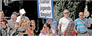  ?? — AP ?? A man holds a banner in Spanish that reads ‘Win by playing fairly’ outside a Madrid court where Cristiano Ronaldo appeared to answer questions as part of a probe in a tax fraud case.