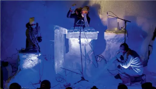  ??  ?? A COOL ACT: Musicians, led by Terje Lsungset (C), entertain the crowd with a finger-numbing performanc­e by playing ice-sculpted musical instrument in Finse village