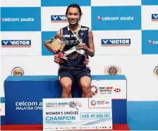  ??  ?? Sensationa­l: Taiwan’s Tai Tzu Ying posing with the trophy and the mock cheque after winning the women’s singles title at the Celcom Axiata Malaysian Open yesterday.