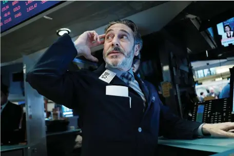  ?? GETTY IMAGES ?? HIGH ANXIETY: Traders work on the floor of the New York Stock Exchange on Moonday in New York. Stocks again fell sharply on Wall Street despite a drop in interest rates as the nation grapples with the spreading coronaviru­s outbreak.