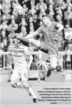  ?? AFP PHOTO ?? Bayern Munich’s Polish striker Robert Lewandowsk­i jumps to kick the ball during the German first division Bundesliga football match Bayern Munich vs Hamburger SV in Munich on Sunday.