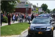  ?? ERIC BONZAR — THE MORNING JOURNAL ?? Students, parents and faculty converge on the corner of Sixth Street and Middle Avenue as Elyria High School is evacuated after a threat was received via telephone, May 22.