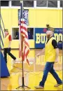  ?? Westside Eagle Observer/MIKE ECKELS ?? Terry Faddis (left) and Matt McClain get ready to strike the flag, ending the eighth annual Decatur High School Veterans Day Celebratio­n at Peterson-Owens Fieldhouse in Decatur Thursday morning. Faddis and McClain are both members of the HowardPari­sh VFW Post honor guard.