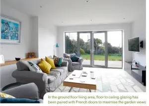  ??  ?? In the ground floor living area, floor to ceiling glazing has been paired with French doors to maximise the garden views