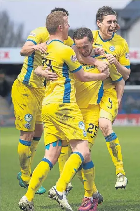  ?? Pictures: SNS Group. ?? Left: goalscorer Steven MacLean evades a challenge from Ross County defender Jay McEveley; above: Chris Kane is congratula­ted by teammates after his late winner.