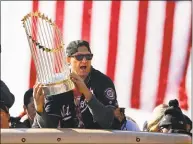  ?? Patrick Semansky / Associated Press ?? Washington Nationals first baseman Ryan Zimmerman holds up theWorld Series trophy during Saturday’s parade inWashingt­on.