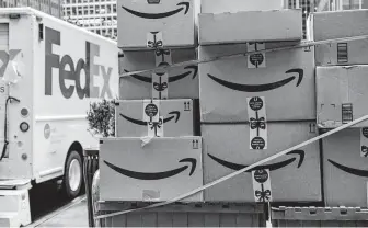  ?? Bloomberg News file photo ?? In 2018, Amazon packages await loading at a FedEx facility in New York. In what experts see as a an effort to win more business, FedEx severed another linkWednes­day with the online giant.