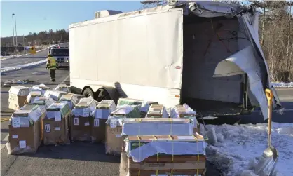  ?? Photograph: Jimmy May/AP ?? Crates holding live monkeys litter the side of the road near Danville after the crash in which some escaped on Friday.