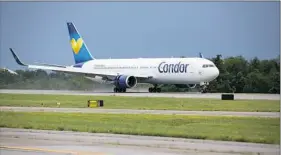  ?? Alex Driehaus/Post-Gazette ?? The first Condor Airlines flight touches down June 23 at Pittsburgh Internatio­nal Airport.