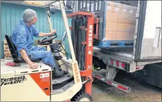  ?? LAWRENCE POWELL ?? Valley Flax Flour Ltd. production manager Wade Russell loads boxes of product onto an 18-wheeler bound for markets in Ontario. The Middleton company was presented with the Annapolis Valley Chamber of Commerce’s Outstandin­g Exporter of the Year award Nov. 1.