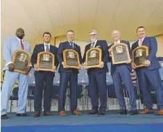  ??  ?? Baseball Hall of Famers, from left, Vladimir Guerrero, Trevor Hoffman, Chipper Jones, Jack Morris, Alan Trammell and Jim Thome hold their plaques after the induction ceremony.