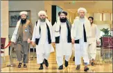  ?? REUTERS ?? The Taliban negotiatin­g team, headed by Abdul Salam Hanafi (R), arrives for peace talks in Doha, Qatar, on Thursday.