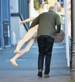  ??  ?? Theatre props...A man carries a mannequin up Stuart St during the Fortune Theatre clearance auction on Saturday.