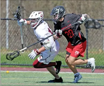 ?? MATT STONE — BOSTON HERALD ?? Concord Carlisle #12Ryan Fivek tries to get away from Hingham #20Will St. Pierre during a lacrosse game.