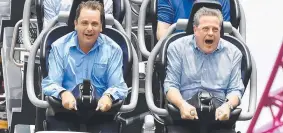  ??  ?? JOYRIDE: Tim Nicholls (right) takes a ride on the DC Rivals Hypercoast­er at the Movie World theme park with Theodore MP Mark Boothman.