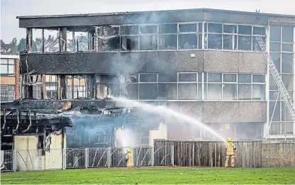  ?? Picture: Steve Brown. ?? Firefighte­rs dampening down at Woodmill High School on August 26 last year.