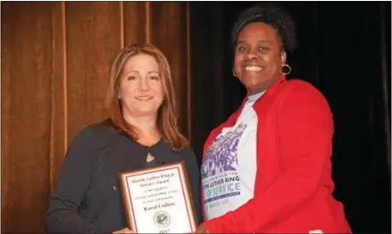  ?? SUBMITTED PHOTO ?? In a tribute to the memory of Martin Luther King Jr., the Coatesvill­e Area School District and the Coatesvill­e Youth Initiative presented three awards for service to others. Chaya Scott, executive director of the Coatesvill­e Youth Initiative, presents...