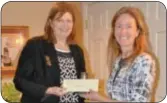  ??  ?? Melissa Mantz, left, of the Bucks County Housing Group, accepts a donation check from MWA President Karen Parmalee.