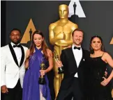  ??  ?? Joanna Natasegara, second from left, and Orlando von Einsiedel, winners of the award for best documentar­y short subject for ‘The White Helmets’, pose in the press room with David Oyelowo, left, and Salma Hayek, right, at the Oscars.