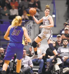  ?? Jessica Hill / Associated Press ?? UConn’s Katie Lou Samuelson leaps to keep a ball in play as DePaul’s Kelly Campbell (20) looks on during Wednesday’s win at the XL Center in Hartford.