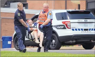  ?? JOHN MINCHILLO/ASSOCIATED PRESS ?? Emergency personnel carry a volunteer with simulated injuries during a training exercise May 25 for an active shooter at Hopewell Elementary School in West Chester, Ohio.