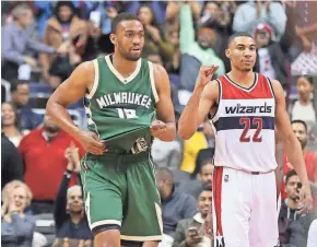  ?? GEOFF BURKE / USA TODAY SPORTS ?? Wizards forward Otto Porter Jr. celebrates as Bucks forward Jabari Parker walks off the court after the final horn in Milwaukee’s 107-102 loss Monday night at the Verizon Center.