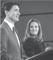  ?? DAVID KAWAI/BLOOMBERG ?? Foreign Affairs Minister Chrystia Freeland, right, listens as Prime Minister Justin Trudeau reveals the details of the new USMCA deal on Oct. 1, which was reached at the 11th hour the day before.