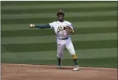  ?? JEFF CHIU — THE ASSOCIATED PRESS ?? Oakland Athletics second baseman Tony Kemp throws out the Houston Astros’ Carlos Correa at first base during the third inning Saturday in Oakland.