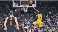  ??  ?? DAVID RICHARD/USA TODAY SPORTS Pacers’ Victor Oladipo (R) goes up for the basket against Cavaliers in Game 1 of an NBA basketball first-round playoff series in Cleveland on April 15, 2018.