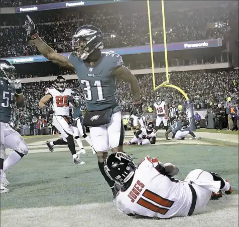  ??  ?? Philadelph­ia’s Jalen Mills celebates after a fourth-down pass to Atlanta’s Julio Jones went through his hands and fell incomplete in the end zone Saturday night in Philadelph­ia.